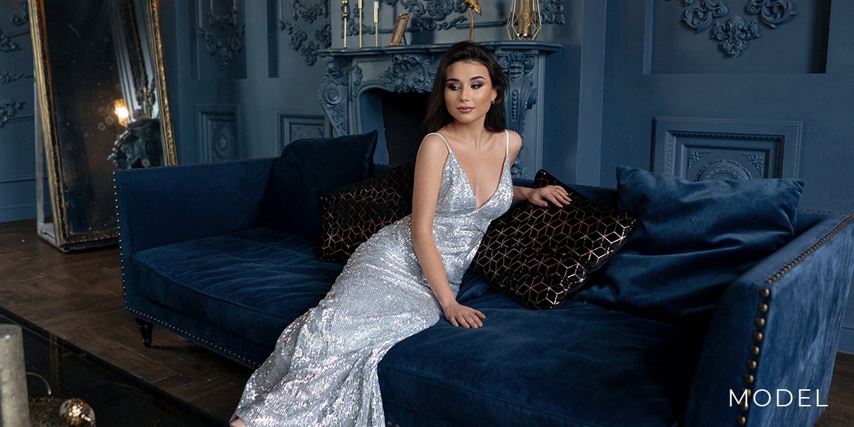 Model in Silver Dress Leans on a Couch